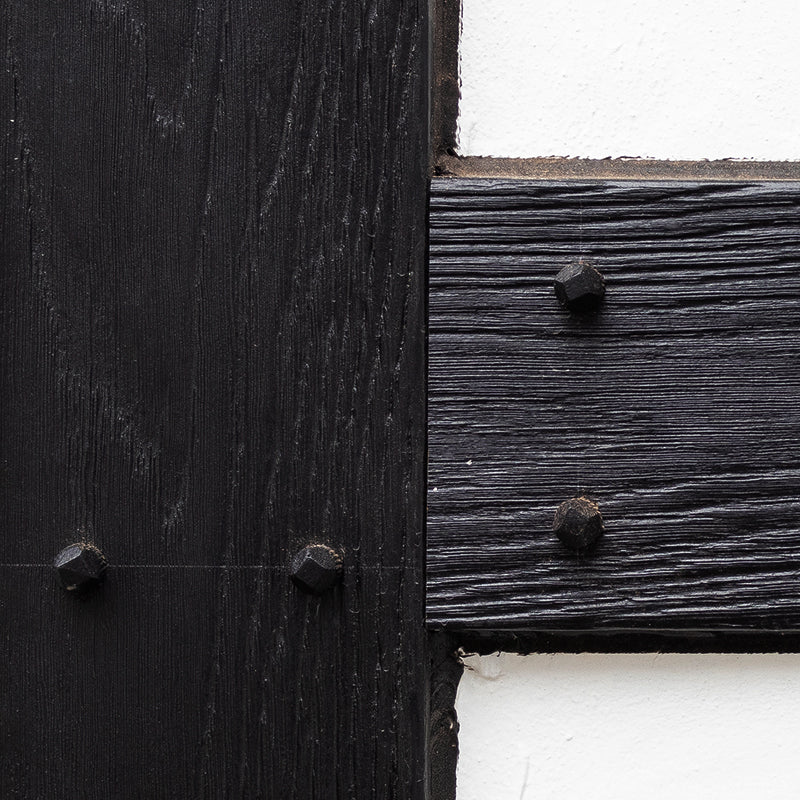 a close up image of a house wall showing the authrntic fixings of the tudor board