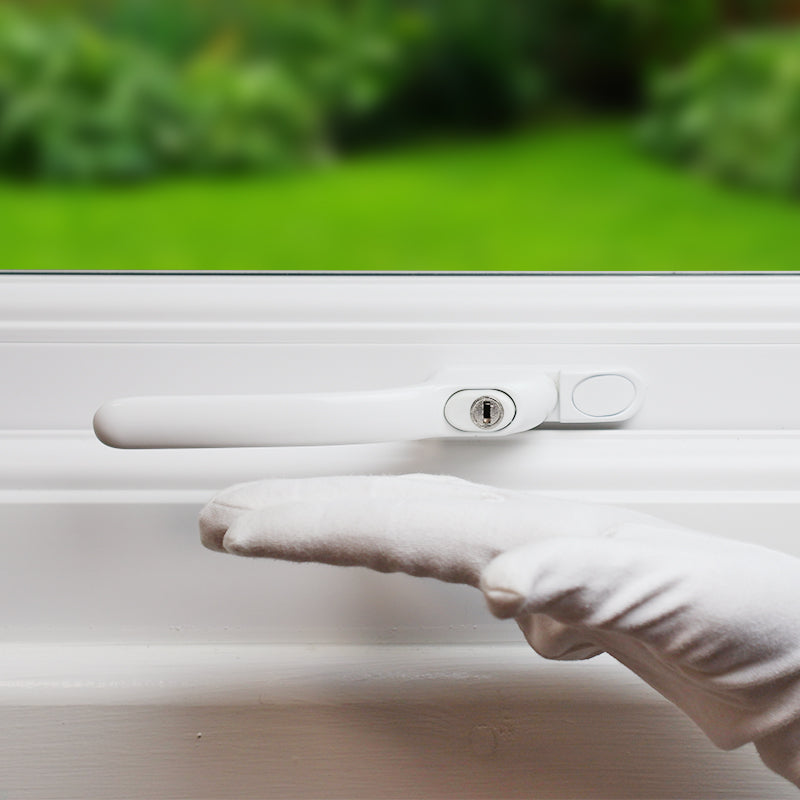 an image showing an inline handle installed on a window in its closed position